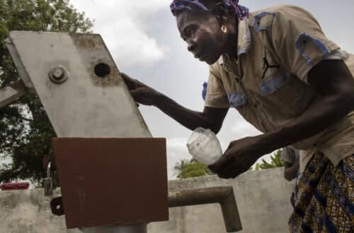 Community member using a hand pump in Sierra Leone — UNDP inclusive growth programme photo