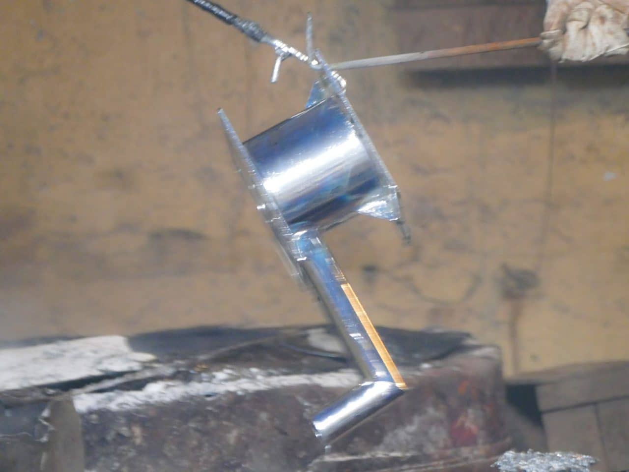 Hand pump component being pulled from the molten zinc bath during hot-dip galvanising at the SKI factory