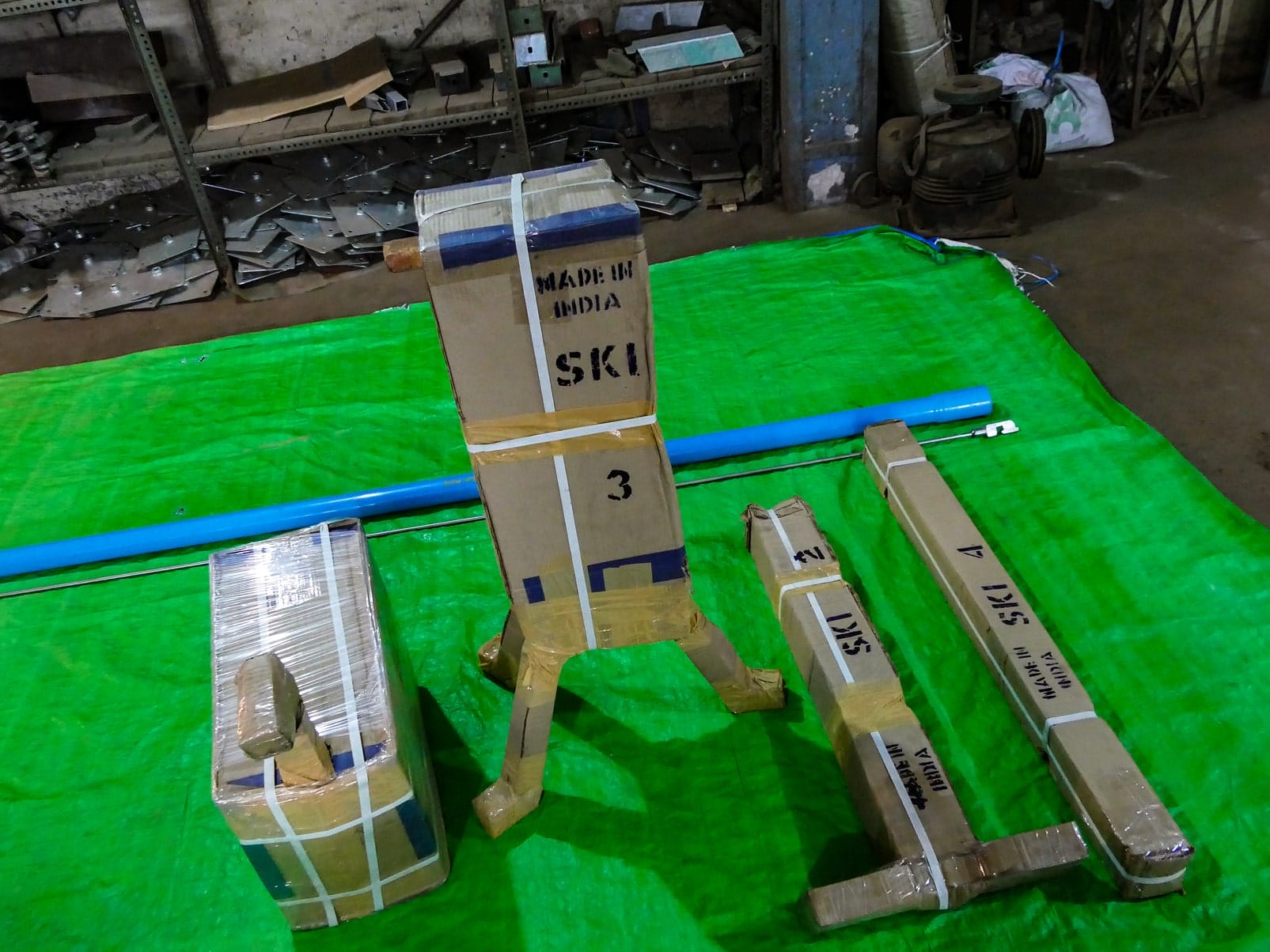P1070006 Hand pump stand legs and riser pipe individually packed in cardboard, marked "Made in India SKI"