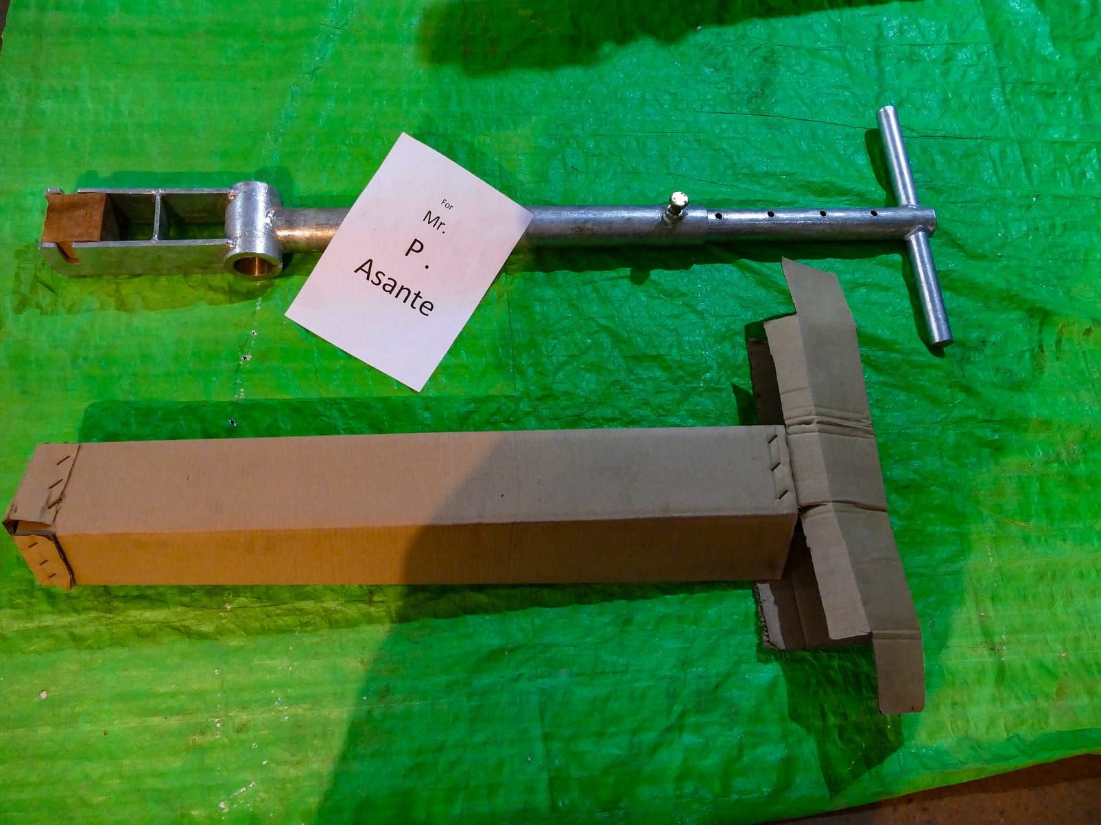 P1070014 India Mark 2 hand pump handle assembly and packed riser pipe box, labeled for a customer order