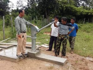 afridevlaos1 Men operating a completed SKI Afridev hand pump on a new concrete platform in Laos