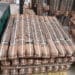 Pallet of hessian-wrapped hand pump parts staged for loading at the SKI warehouse