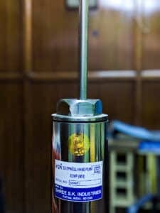 Close-up of the branded label on an SKI stainless steel cylinder showing deepwell hand pump specifications